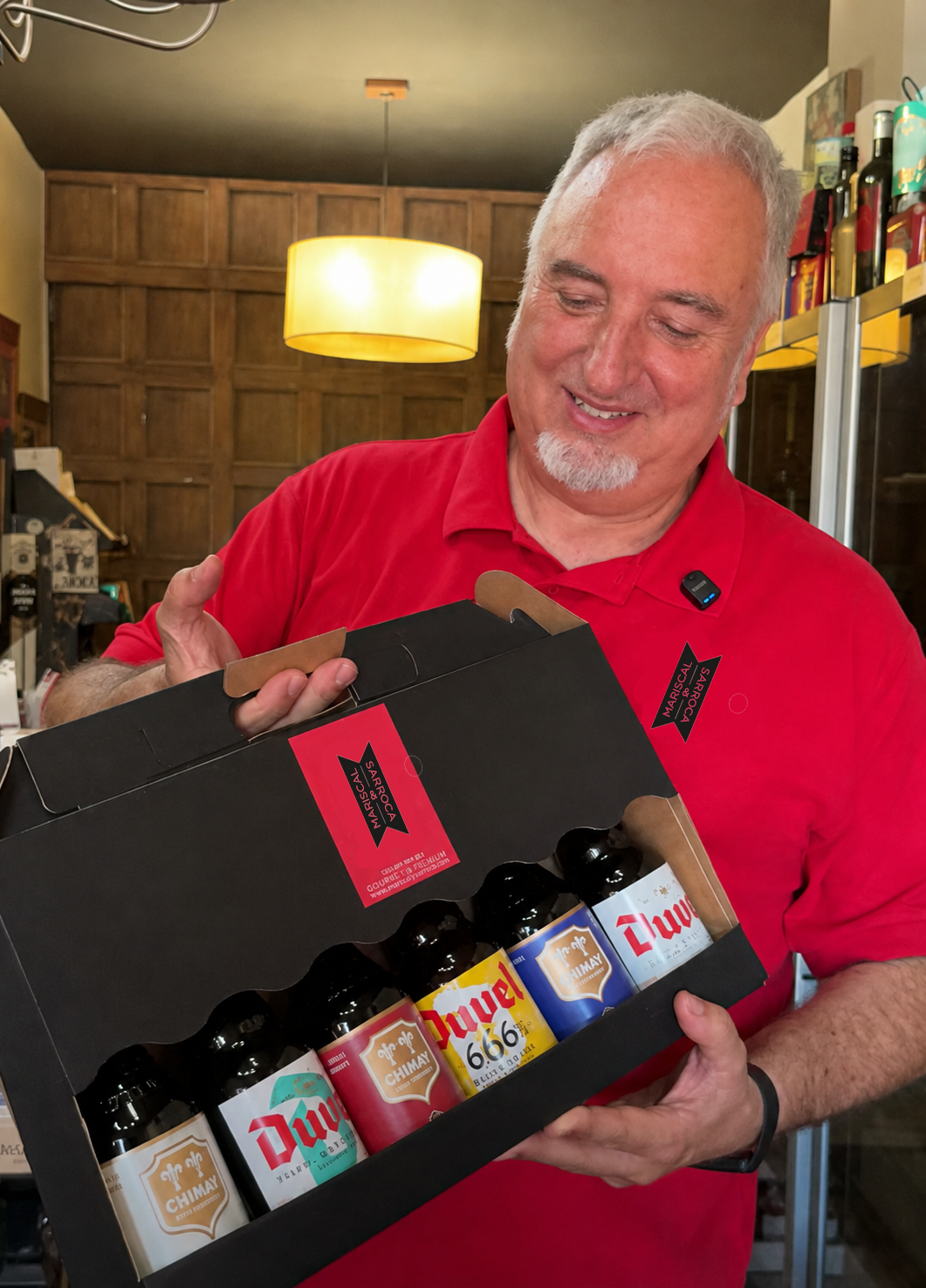 El propietario de Gourmet Altafulla presentando una caja regalo con cervezas artesanas Duvel y Chimay